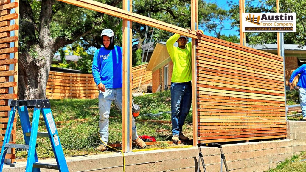 men installing wooden privacy fence