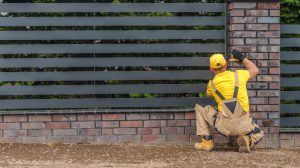 person inspecting metal fence