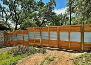 Residential privacy fence with corrugated sheet accents