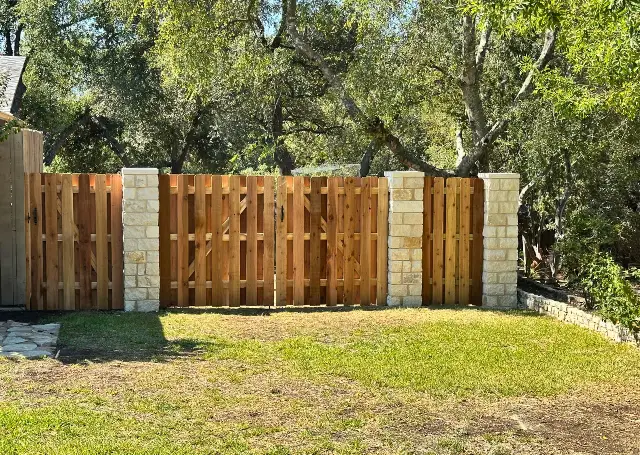 Stone post wooden fence for a rustic touch