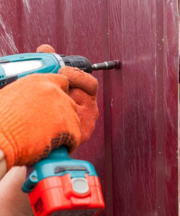 person drilling iron sheet