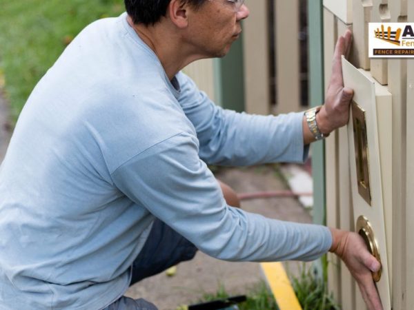 What’s-the-Average-Fence-Replacement-Cost man installing wood planks on fence